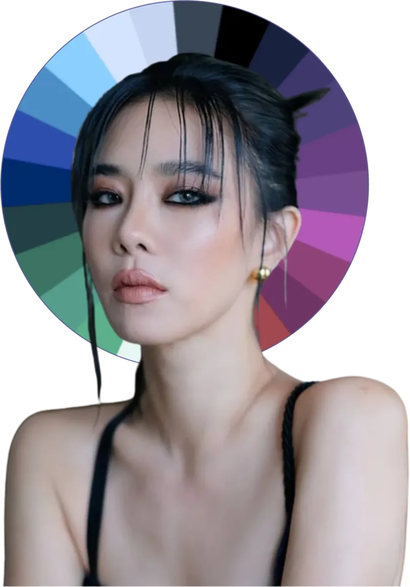 A woman with cool high-contrast features framed by a winter color wheel in jewel tones, true black, and pure white